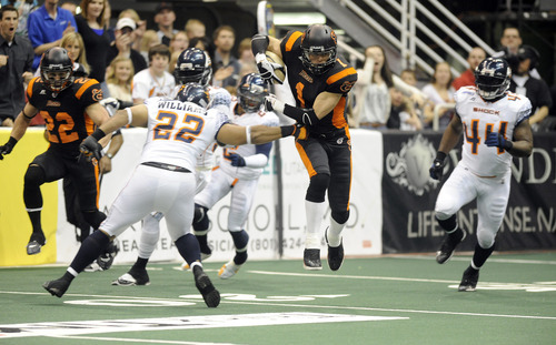 Sarah A. Miller  |  The Salt Lake Tribune

Utah Blaze's wide receiver Aaron Boone drives down the field past Spokane's (22) Jon Williams Friday night at Energy Solutions Arena in downtown Salt Lake City.