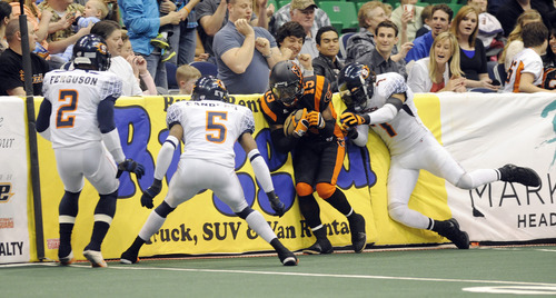 Sarah A. Miller  |  The Salt Lake Tribune

Utah Blaze's wide receiver Alvance Robinson is surrounded by Spokane Shock players Friday night at Energy Solutions Arena in downtown Salt Lake City.