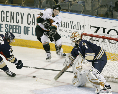 Rick Egan   |  The Salt Lake Tribune

Brett Parnham (28) takes a shot for the Grizzlies, as Jeff Caister (44) and goal keeper David Shantz (1) defend for the Salmon Kings, in hockey action, Utah Grizzlies vs. Victoria Salmon Kings, at the Maverick Center, Saturday, April 16, 2011