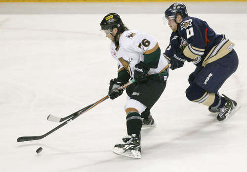 Rick Egan   |  The Salt Lake Tribune

Grizzlies Paul McIlveen (76) goes for the puck along with Salmon King, Adam Taylor, in hockey action, Utah Grizzlies vs. Victoria Salmon Kings, at the Maverick Center, Saturday, April 16, 2011