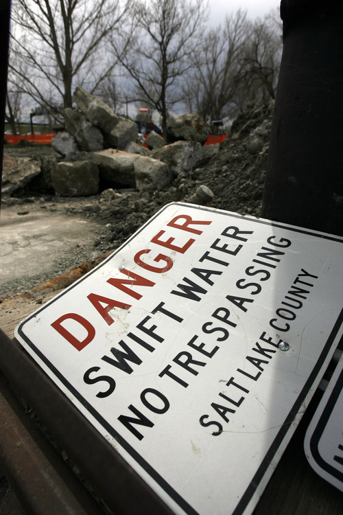 Francisco Kjolseth  |  The Salt Lake Tribune
A sign warns of swift water as crews working for Salt Lake County, which has jurisdiction over Little Cottonwood Creek, shore up walls in Murray Park on Wednesday, March 13, 2011, in anticipation of possible flooding for this year's spring runoff.