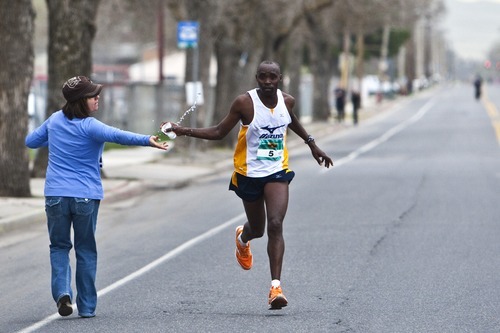 Photo by Chris Detrick | The Salt Lake Tribune 
Jonathan Ndambuki gets water as he competes during the 2011 Salt Lake Marathon Saturday April 16, 2011. Ndambuki won the marathon with a time of 2:25.56.