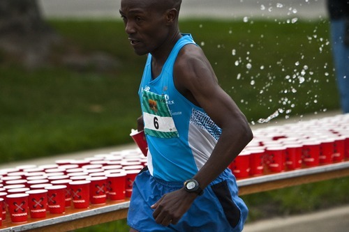 Photo by Chris Detrick | The Salt Lake Tribune 
Joseph Mutinda grabs a cup of water during the 2011 Salt Lake Marathon Saturday April 16, 2011.