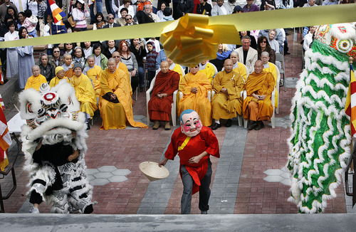 Scott Sommerdorf  |  The Salt Lake Tribune
Lion dancers parade up the steps near the end of the outside ceremony and are about to lead the monks up the stairs to cut the ceremonial ribbon opening the Lien Hoa Buddhist Temple.  The Lien Hoa Buddhist Temple opened Sunday after a decade of planning, Sunday, April 17, 2011.