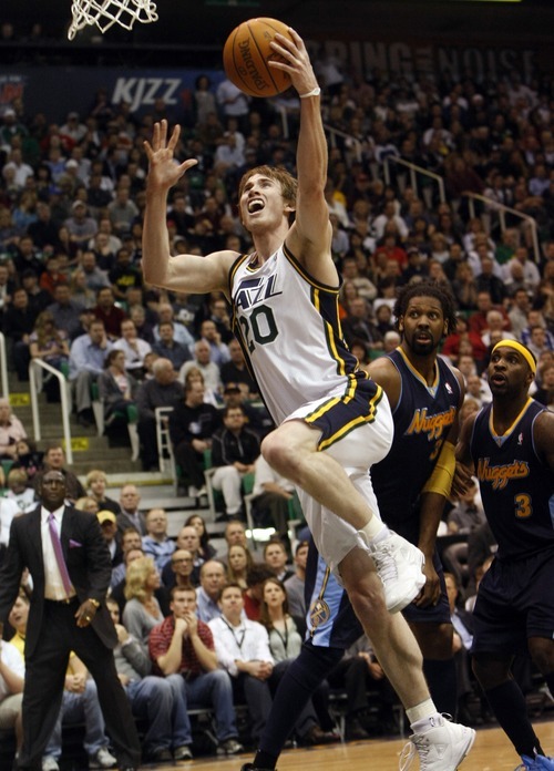 Photo by Chris Detrick | The Salt Lake Tribune 
Utah Jazz small forward Gordon Hayward (20) shoots past Denver Nuggets center Nene (31) and Denver Nuggets point guard Ty Lawson (3) during the first half of the game at EnergySolutions Arena Thursday March 3, 2011.