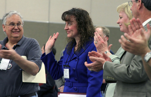 Francisco Kjolseth  |  The Salt Lake Tribune
Julie Dole waves to supporters after getting the vote as the new chairman of the Salt Lake County Republican Party. Dole won the nomination during the GOP convention on Saturday, April 16, 2011, at the South Towne Expo Center in Sandy where new leaders were elected.