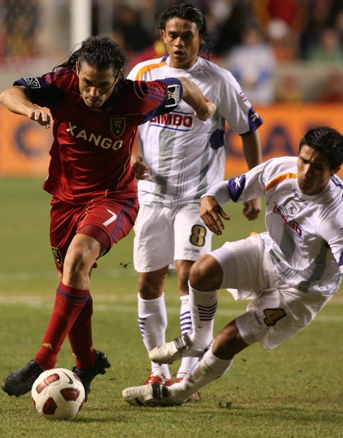 Leah Hogsten  |  The Salt Lake Tribune
Real Salt Lake's Fabian Espindola topples Saprissa's Jose Mena who trips on his own. Real Salt Lake  played the first  its two-game series against Saprissa of Costa Rica in the CONCACAF Champions League at Rio Tinto Stadium  Tuesday March 15, 2011.