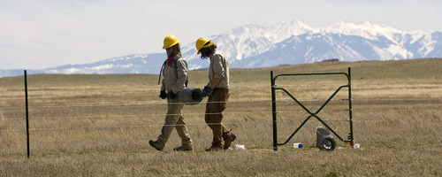 Al Hartmann   |  The Salt Lake Tribune 
August Koehler of Logan, left, and Shane Nelson of Colorado Springs, Colo., members of the Canyon Country Youth Corps, build a fence for the Bureau of Land Management in the open grazing country just south of I-70 near Moab on Monday, April 11.     President Obama's outdoor initiative calls for more outdoor jobs for youths.