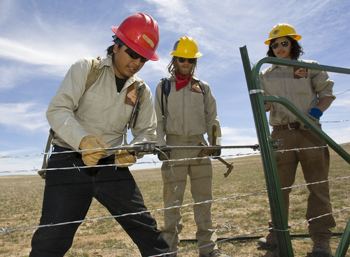 Al Hartmann   |  The Salt Lake Tribune 
Edward Rockbridge of Pinion, Ariz., left,  August Koehler of Logan, and Shane Nelson of Colorado Springs, Colo., are members of the Canyon Country Youth Corps. They are pictured building a fence for the Bureau of Land Management in open grazing country just south of I-70 near Moab on Monday, April 11.     President Obama's outdoor initiative calls for more outdoor jobs for youths.