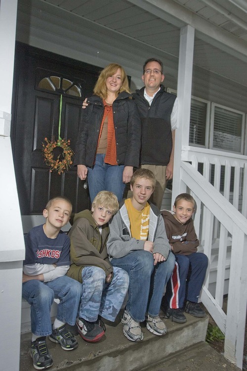 Paul Fraughton  |  The Salt Lake Tribune
The Scheffner family on the front porch of their Sandy home. Parents Gary and Jennifer, top step, are parents to four boys, from left, Zach, Jake, Ben and Sam.