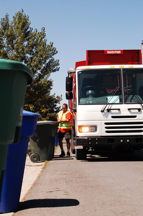 The Salt Lake Tribune file photo
Ace's Kelly Valdez picks up the blue recycling bins in a West Jordan neighborhood. County officials are debating a garbage fee increase that could translate to a hike for residents.