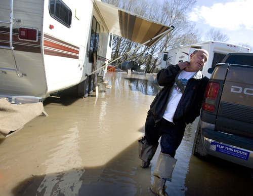 Al Hartmann   |  The Salt Lake Tribune 
Doug Mallette ponders the wet situation next to his trailer at the Riverside R.V. Park that sits along the Logan River just south of Logan.   The park is  drying out from the rains on Monday when the river rose over the banks and into the park.   He laughed and said that it's like living in Venice, Italy.