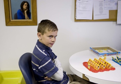 Trent Nelson  |  The Salt Lake Tribune
Ten-year-old Mason Patten looks to his mother, Amanda, who is reflected in the mirror, at a Primary Children's rehabilitation clinic in Sandy April 12. An initiative funded by the Utah Department of Health has encouraged about 30 physician offices to screen all of their pediatric patients at age 18 months and again at 24 months for autism.