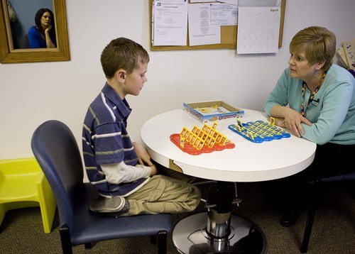 Trent Nelson  |  The Salt Lake Tribune
Speech pathologist Jonel Condra works with 10-year-old Mason Patten at a Primary Children's rehabilitation clinic in Sandy April 12. Patten's mother, Amanda Patten, reflected in the mirror at left, says the years of speech and occupational therapy have made a huge difference.