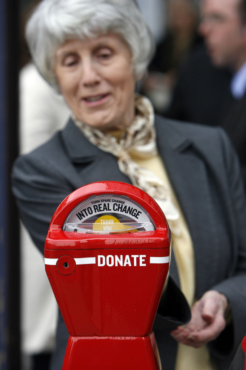 Francisco Kjolseth  |  The Salt Lake Tribune
Pamela Atkinson, champion for the homeless feeds one of the meters to be used as donation stations to aid panhandlers and the homeless. Nine of the red meters made their debut on downtown sidewalks on Thursday, April 21, 2011 during a press event with the mayor, police chief and service providers in front of the Zions Bank with one of the new meters at South Temple and Main.