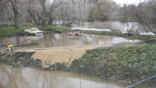 Tom Wharton  |  The Salt Lake Tribune

Pumps and sandbags are in use near a home on the Ogden River at the Marriott-Slaterville city limits, where the river was running high and muddy during Thursday's storm.
