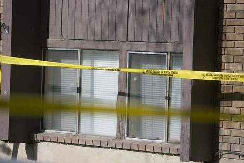 Jeremy Harmon  |  The Salt Lake Tribune

Crime scene tape hangs in front a window at the scene of an apparent double homicide in South Salt Lake on Friday, April 22, 2011. A man reported finding two of his roommates dead inside the apartment earlier in the morning.