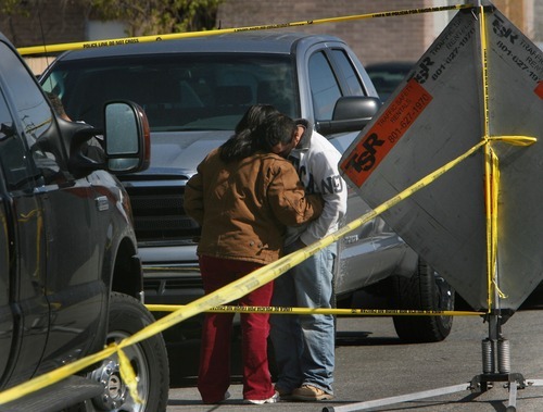 Steve Griffin  |  The Salt Lake Tribune

Two people embrace outside a South Salt Lake City apartment  where the bodies of a man and a woman were discovered by a roommate Friday, April 22, 2011. South Salt Lake police are investigating the deaths as a double homicide at this time.