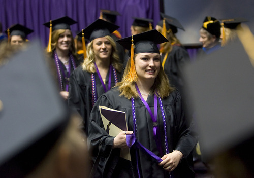 Al Hartmann  |  The Salt Lake Tribune 
Weber State University graduates walk in procession past faculty into the Dee Events Center on Friday, April 22, for the university's 137th commencement.