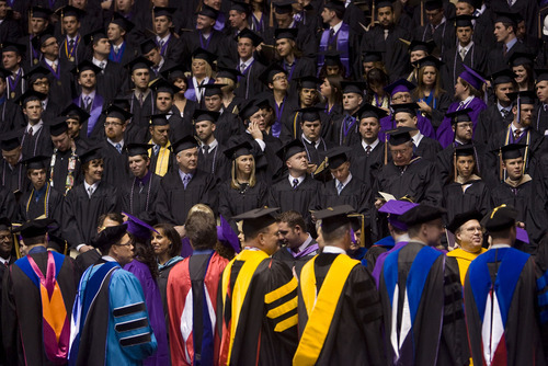Al Hartmann  |  The Salt Lake Tribune 
Weber State University graduates walk past faculty into the Dee Events Center on Friday, April 22, for the university's 137th commencement.