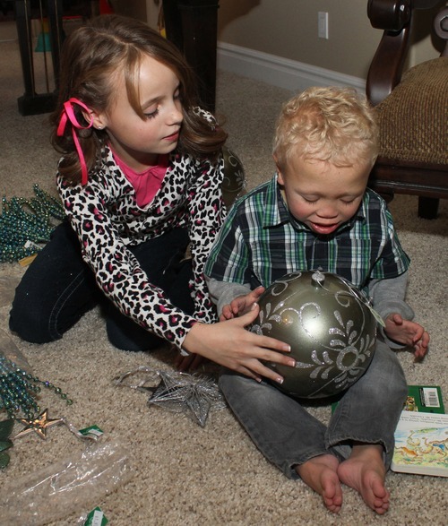 Rick Egan   |  The Salt Lake Tribune

8-year-old Abbey Howe looks at Christmas decorations with her 4-year-old brother Deakon, who has a rare chromosomal disorder. Saturday, November 20, 2010. Abbey is decorating a tree for the Festival of Trees for her Deakon.