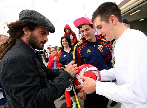 Leah Hogsten  |  The Salt Lake Tribune
Real Salt Lake's Kyle Beckerman signs the soccer ball of John Gillis. Real Salt Lake was greeted by about 60 fans when the team landed at Million Air Terminal in Salt Lake City on Thursday, April 21, 2011. The Major League Soccer team returned from a 2-2 tie Wednesday against Mexican champions Monterrey in the first leg of the CONCACAF Champions League Final.