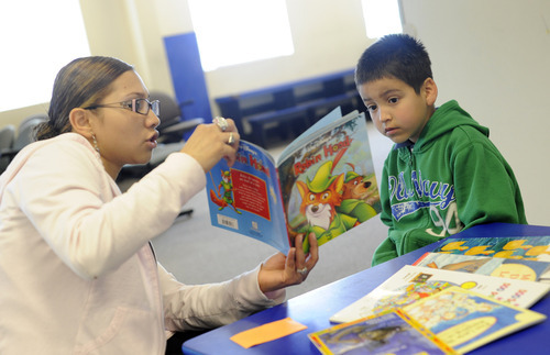 Sarah A. Miller  |  The Salt Lake Tribune

Medical assistant Eldy Baltodoano reads a book to patient Oscar Izarraraz, 7, of Midvale, in the Reach Out and Read area in the waiting room before his appointment at Oquirrh View Community Health in Taylorsville Monday April 25, 2011.