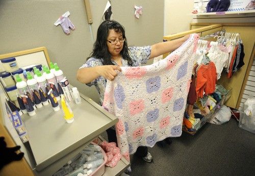 Sarah A. Miller  |  The Salt Lake Tribune

Clinical care coordinator Emily Garcia displays some of the donated items available at the Teddy Bear Den store for expecting mothers at Oquirrh View Community Health in Taylorsville Monday April 25, 2011.