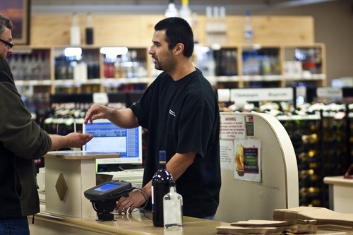 Chris Detrick | The Salt Lake Tribune 
Nathan Candelario works at the the Utah State Liquor Store at 402 E. 6th Ave. on  Tuesday April 26, 2011. Nine Utah liquor stores targeted for closing this summer will stay open at least until February of next year. In addition, store operating hours will not be cut, and more than 100 liquor store employees, slated for layoffs, will keep their jobs.