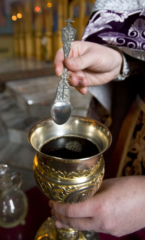 Al Hartmann   |  The Salt Lake Tribune 
Fr. Justin Havens, an Antiochian Orthodox priest demonstrates mixing of water and wine into a chalice for communion.   Bread is soaked in the chalice and served on an ornate silver spoon at Saints Peter and Paul Antiochan Orthodox Christian Church  in Salt Lake City.