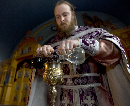 Al Hartmann   |  The Salt Lake Tribune 
Fr. Justin Havens, an Antiochian Orthodox priest, demonstrates mixing of water and wine into a chalice for communion.   Bread is soaked in the chalice and served on an ornate silver spoon at Saints Peter and Paul Antiochan Orthodox Christian Church in Salt Lake City.