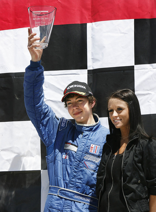 Scott Sommerdorf  |  The Salt Lake Tribune
Madison Snow of Pleasant Grove stands atop the winners platform after wining the GT3G - Gold Class - event of the IMSA GT3 Cup Challenge held at Miller Motorsports Park, Sunday, May 1, 2011.