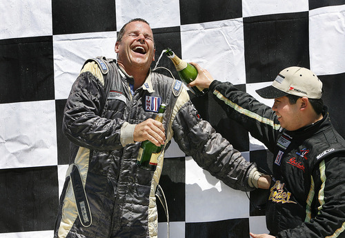 Scott Sommerdorf  |  The Salt Lake Tribune
First place finisher Tim McKenzie gets champagne poured down his racing suit by second place finisher Brian Wong (right) on the winners podium for the GT3-Platinum Class event of the IMSA GT3 Cup Challenge held at Miller Motorsports Park, Sunday, May 1, 2011. Pleasant Grove's Melanie Snow finished fifth in the event.