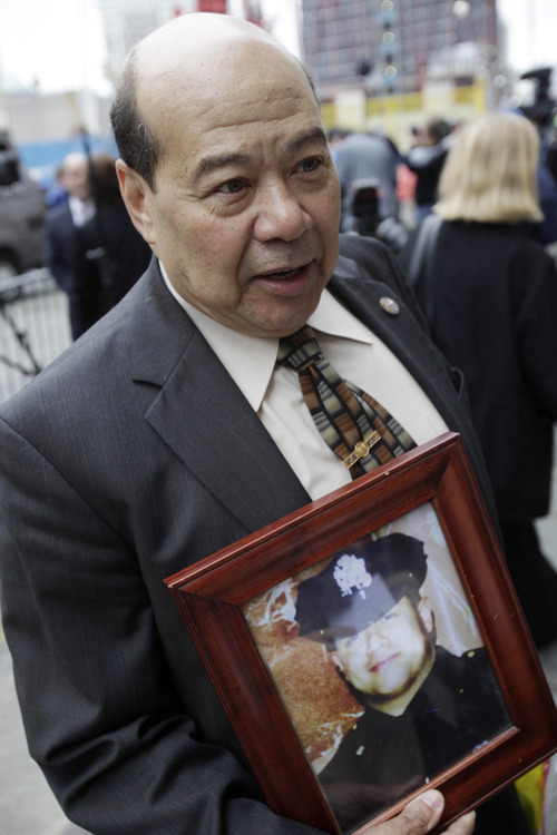 Prudencio Lemagne holds a picture of his son, David Lemagne, who was killed on Sept. 11, 2001 at the site of the terrorist attack, while speaking to reporters at ground zero in New York, Monday, May 2, 2011. Osama bin Laden, the face of global terrorism and architect of the Sept. 11, 2001, attacks, was killed in a firefight with elite American forces in Pakistan on Monday, May 2, 2011 then quickly buried at sea. (AP Photo/Seth Wenig)