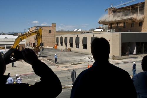 Chris Detrick | The Salt Lake Tribune 
Spectators watch as properties neighboring the Nu Skin high-rise building are demolished Wednesday.