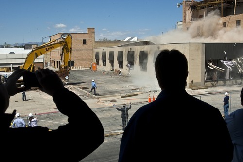 Photo by Chris Detrick | The Salt Lake Tribune 
Spectators watch as properties neighboring the Nu Skin High Rise are demolished Wednesday May 4, 2011.  The Nu Skin Innovation Center will house world-class research and development laboratory, network operations center, distributor recognition areas, retail space and a café. Nu Skin is investing $80 million in downtown Provo with this expansion project that will include more than one acre of green space for employees, residents and visitors to enjoy.