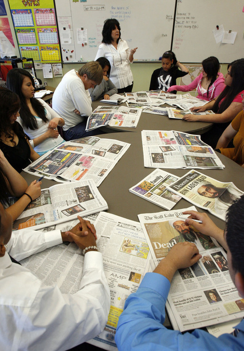 Francisco Kjolseth  |  The Salt Lake Tribune
East High teacher Cate Praggastis, center top, leads a discussion over the big news of the day on Monday, May 2, 2011, where the first group of students to go through East High's AVID (Advancement Via Individual Determination) program for four years are graduating. The program is aimed at kids who have potential and determination but not necessarily parental support or much knowledge about how to get into college, apply for scholarships, etc. Students attend (elective) AVID class every other day throughout high school with the main focus preparing for college. The 16 have become a tight-knit group of kids from tough backgrounds who are supporting each other and encouraging each other to succeed. Several have already received scholarships.