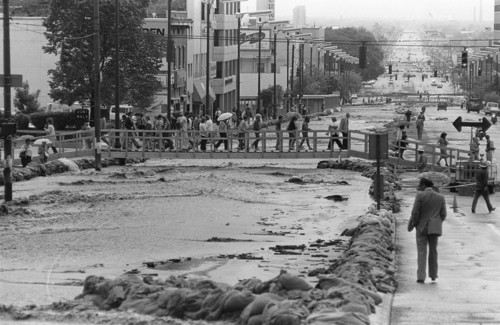 Al Hartmann | The Salt Lake Tribune 
Life went on for downtown pedestrians and workers after construction crews quickly built footbridges over the State Street river in late May 1983 after City Creek had to be diverted down the road.