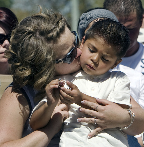 Steve Griffin  |  The Salt Lake Tribune

Jessica Yazzie kisses her son Jaxsen during a memorial service at the Law Enforcement Memorial on the Capitol grounds  in Salt Lake City on Thursday, May 5, 2011. Jessica's husband, Bureau of Indian Affairs Officer Joshua Yazzie, 33, died in 2010 after his car went over a 200-foot embankment near Bottle Hollow Reservoir on the Ute Indian Reservation in Uintah County.