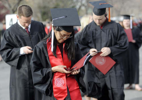 Sarah A. Miller  |  The Salt Lake Tribune

Rinna Waddhany, a mass communications student from West Valley, texts as she waits in line for the University of Utah commencement ceremony to begin at the Huntsman Center on Friday, May 6, 2011, in Salt Lake City. Over 7,000 students received their degrees.