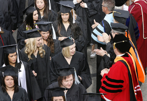 Scott Sommerdorf  |  The Salt Lake Tribune
Students are applauded by faculty as they walk in the processional to The Spectrum for Utah State's Graduation in Logan, Saturday, May 7, 2011.