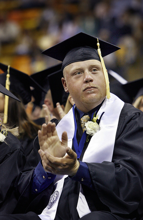 Scott Sommerdorf  |  The Salt Lake Tribune
Robbie Petersen, a survivor of the 2005 van accident that killed eight students and an instructor, applauds as teachers in the audience are recognized during Utah State's Graduation in Logan, Saturday, May 7, 2011.