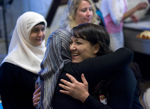 Al Hartmann  |  The Salt Lake Tribune
Angela Young, a convert to Islam, gives a hug to Muslim friend Kirin Nabi at the Wasatch Presyterian Church on Thursday. Several women from the Muslim community brought a traditional lunch to the Wasatch Presbyterian Church women's group and ate together on Thursday.  It was a thank-you to the church board, which bought dozens of copies of the Quran to be distributed, free of charge, to anyone interested in reading Islam's holy book.