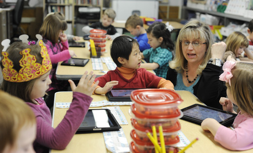 Sarah A. Miller  |  The Salt Lake Tribune
Viewmont Elementary School kindergarten teacher Jennifer Lightfoot helps students Ella Hayes, 5, left, Sophia Park, 5, and Hailey Fielding, 6, use a coin matching app on their iPads April 25 in Murray. Lightfoot received a grant from the State Office of Education to purchase 27 iPads with educational apps for her students to use in class.