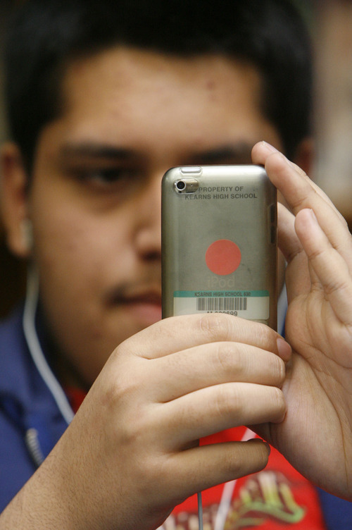 Francisco Kjolseth  |  The Salt Lake Tribune
Daniel Hurtado, 16, a junior at Kearns High School, studies with his iPod touch during a recent break in the school library. For the past six months, the whole school has adopted the iPod, including the teachers to exploit the potential of learning through technology.