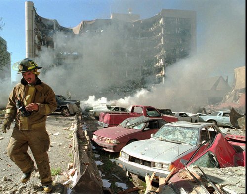 In this April 19, 1995 file photo, an Oklahoma City fireman walks near explosion-damaged cars on the north side of the Alfred Murrah Federal Building in Oklahoma City after a car bomb blast. More than 600 people were injured in the attack and 168 people were killed. Timothy McVeigh was executed in 2001 and Terry Nichols is serving multiple life sentences on federal and state convictions for their convictions in the bombing. (AP Photo/The Daily Oklahoman, Jim Argo, File)