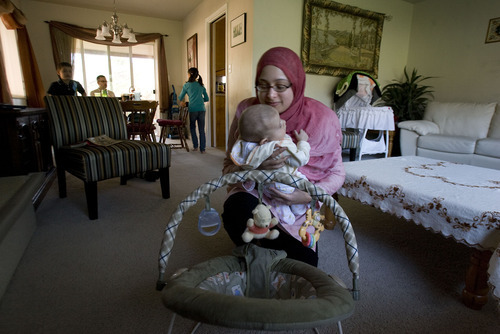 Steve Griffin  |  The Salt Lake Tribune

 Arshia Kergaye puts her newborn baby Noah down for a nap during dinner with her son Zain, daughter Leena and husband Cameron during dinner at their Millcreek home on Wednesday, May 4, 2011. Kergaye's fourth child Adam is not in the picture.