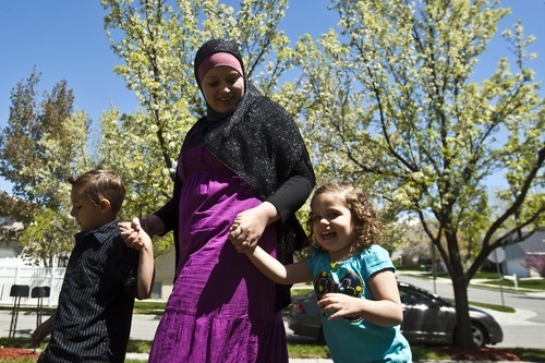 Chris Detrick | The Salt Lake Tribune 
Sharifa Al-Qaaydeh and her kids Sajed, 5, and Summer, 3, walk around their home Wednesday May 4, 2011.