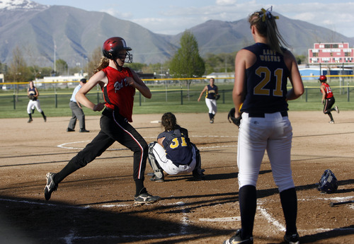 Photo by Chris Detrick | The Salt Lake Tribune 
Grand's Carly Dalton (4) scores a run past Enterprise's Caprice Christensen (31) and Kelsey Lee (21) during the game in Spanish Fork Thursday May 12, 2011.
