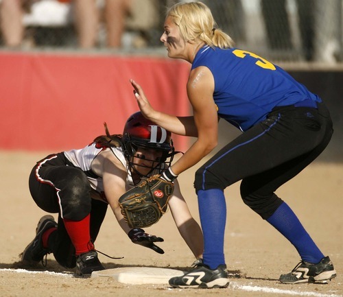 Trent Nelson  |  The Salt Lake Tribune
Grand County's Merina Toninelli dives back to third as San Juan's L'Sha Eldrege waits for the ball. San Juan defeats Grand County High School 3-1 in 2A girls softball, in Spanish Fork, Utah, Friday, May 13, 2011.